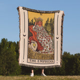 Blanket with 'The Empress' tarot card design held by a person in a field