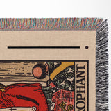 Close-up of a tarot card-style design on a woven fabric with colorful fringe.