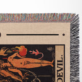 Blanket close-up with a design of  the Devil tarot card and colorful fringe.