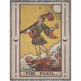 Tarot card-style artwork of 'The Fool' with a person holding a bag and a dog, on a woven blanket.