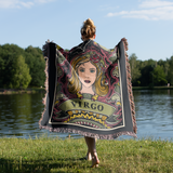 Person holding a 'Virgo' themed blanket by a lake
