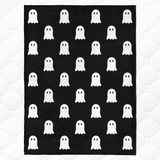 Black blanket with white ghost pattern on a white background